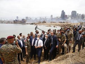 French President Emmanuel Macron (C), flanked by French Foreign Affairs Minister Jean-Yves Le Drian (C,R) visits the devastated site of the explosion at the port of Beirut, on August 6, 2020 two days after a massive explosion devastated the Lebanese capital in a disaster that has sparked grief and fury. French President Emmanuel Macron visited shell-shocked Beirut on August 6, pledging support and urging change after a massive explosion devastated the Lebanese capital in a disaster that left 300,000 people 