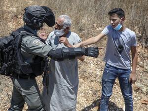 A member of Israeli security argues with a Palestinian demonstrator during a rally to protest Israel's plan to annex parts of the occupied West Bank, in the Palestinian village of Haris, southwest of Nablus, on August 7, 2020. JAAFAR ASHTIYEH / AFP