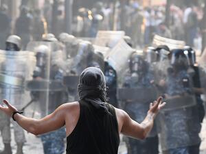 A Lebanese protester gestures towards security forces during clashes in downtown Beirut on August 8, 2020, following a demonstration against a political leadership they blame for a monster explosion that killed more than 150 people and disfigured the capital Beirut. AFP A Lebanese protester gestures towards security forces during clashes in downtown Beirut on August 8, 2020, following a demonstration against a political leadership they blame for a monster explosion that killed more than 150 people and disfigured the capital Beirut. AFP