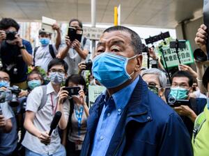 In this file photo taken on May 18, 2020, Hong Kong media tycoon and founder of the Apple Daily newspaper Jimmy Lai (C) arrives at the West Kowloon Magistrates Court for charges related to last year's protests in Hong Kong. Anthony WALLACE / AFP
