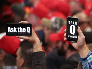 In this file photo taken on February 21, 2020 supporters of President Donald Trump hold up their phones with messages referring to the QAnon conspiracy theory at a campaign rally at Las Vegas Convention Center in Las Vegas, Nevada. (AFP)