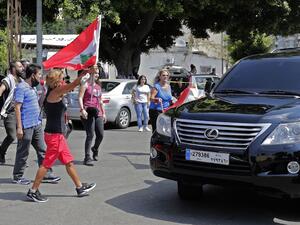 Lebanese anti-government protesters attack a vehicle belonging to a member of the parliament upon his arrival to the parliamentary session at the UNESCO Palace in Beirut, on August 13, 2020. ANWAR AMRO / AFP
