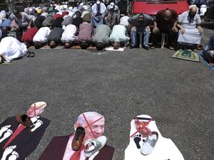Palestinians perform take part in the Friday prayers in front of cut-outs showing the faces of (L to R) Israeli Prime Minister Benjamin Netanyahu, Abu Dhabi Crown Prince Sheikh Mohammed bin Zayed al-Nahyan, and US President Donald Trump, during a demonstration in Nablus in the occupied West Bank on August 14, 2020 against a US-brokered deal between Israel and the UAE to normalise relations. The deal marks only the third such accord the Jewish state has struck with an Arab nation, an historic shift making th