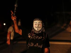 Palestinian protesters calling themselves the 'Night Confusion Units' gather near the Gaza-Israel border east of al-Bureij camp for Palestinian refugees in the central Gaza Strip on August 16, 2020. MAHMUD HAMS / AFP