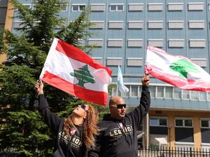 People gather and wave Lebanon national flags in front of the UN-backed Special Tribunal for Lebanon (STL) at Leidschendam on August 18, 2020, before the expected verdict on the 2005 murder of his father former Lebanese premier Rafic Hariri. KENZO TRIBOUILLARD / AFP People gather and wave Lebanon national flags in front of the UN-backed Special Tribunal for Lebanon (STL) at Leidschendam on August 18, 2020, before the expected verdict on the 2005 murder of his father former Lebanese premier Rafic Hariri. KENZO TRIBOUILLARD / AFP