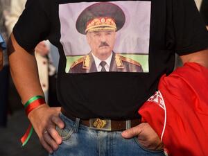 A man wearing a T-shirt with an image of Belarusian President Alexander Lukashenko attends a rally of Lukashenko's supporters in Minsk on August 21, 2020. Belarusian President Alexander Lukashenko vowed on August 21 to resolve his country's political crisis "in the coming days" and accused the United States of "directing" anti-government protesters. Lukashenko is facing the biggest challenge to his 26-year rule after thousands of protesters took to the streets to denounce his claim to have won a sixth term 