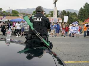 A Los Angeles police officer faces Trump supporters during a pro-Trump rally in Tujunga, a north neighborhood of Los Angeles, August 21, 2020. Kyle Grillot / AFP