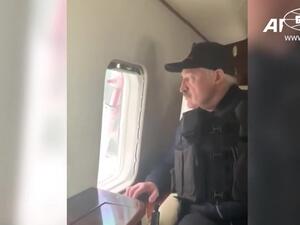 This grab taken from a video released by Belarus state agency "Belta" shows President Alexander Lukashenko wearing a body armour in his helicopter as he arrives, on August 23, 2020, at his residence in Minsk. Tens of thousands of demonstrators massed in central Minsk on Sunday to demand the resignation of Belarusian President Alexander Lukashenko, who flew over the scene of the banned protest in a helicopter and called the marchers "rats". BELTA / AFP