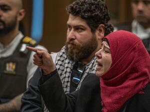 Manal Dokhan (R) gestures towards Australian white supremacist Brenton Tarrant as she gives a victim impact statement on Tarrant's third day in court for a sentence hearing in Christchurch on August 26, 2020. New Zealand mosque gunman Brenton Tarrant waived his right to speak at his sentencing hearing in Christchurch on August 26, in a dramatic twist after the court heard more than 90 horrific victim statements. JOHN KIRK-ANDERSON / POOL / AFP