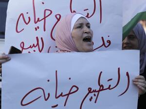 A Palestinian woman shouts slogans equating "normalisation with treachery" during a rally against the US-brokered UAE-Israel deal to normalise relations in the centre of the West Bank city of Nablus on August 26, 2020. (AFP)