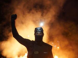 A protester holds his fist in the air during a protest against racial injustice and police brutality early in the morning on August 23, 2020 in Portland, Oregon. Nathan Howard / GETTY IMAGES NORTH AMERICA / Getty Images via AFP