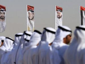 Emirati men perform a traditional dance in front of flags bearing portraits of Abu Dhabi's Crown Prince Sheikh Mohammed bin Zayed al-Nahyan, February 9, 2016. (AFP/Karim Sahib/ File) Emirati men perform a traditional dance in front of flags bearing portraits of Abu Dhabi's Crown Prince Sheikh Mohammed bin Zayed al-Nahyan, February 9, 2016. (AFP/Karim Sahib/ File)