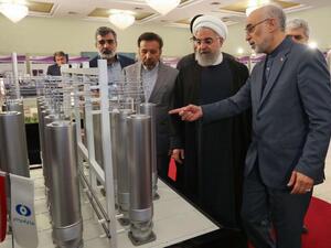 Iranian President Hassan Rouhani (2nd L) listening to head of Iran's nuclear technology organisation Ali Akbar Salehi (R) during the "nuclear technology day" in Tehran. (AFP)