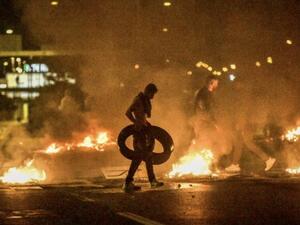 Demonstrators burn tyres during clashes with police in the Rosengard neighbourhood of Malmo, Sweden, on August 28, 2020. The protest was sparked by the burning of a coran by members of Danish far-right party Stram Kurs during an anti-Muslim rally in Malmo earlier in the day. The party's leader Rasmus Paludan, known for his anti-Muslim rhetoric, was due to attend the rally but he was arrested near Malmo and has been banned from Sweden for two years, authorities said on August 28. TT NEWS AGENCY / AFP