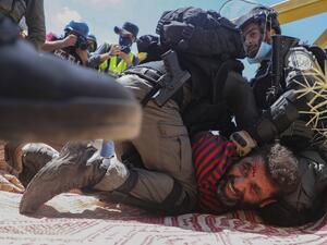 Members of the Israeli security forces arrest a Palestinian demonstrator during a rally to protest against Israel's plan to annex parts of the occupied West Bank, in the village of Haris, southwest of Nablus, on August 21, 2020. JAAFAR ASHTIYEH / AFP