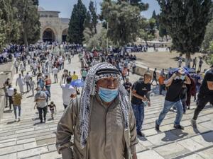 Palestinian Muslims leave after performing the Friday prayer outside the Dome of the Rock Mosque, in Jerusalem's Al-Aqsa mosques compound, amid the novel coronavirus pandemic crisis, on August 21, 2020. AHMAD GHARABLI / AFP