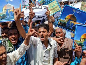 Demonstrators chant slogans with signs depicting Jerusalem's Dome of the Rock alongside other signs reading in Arabic "no to normalisation with the Zionist entity", during a protest in Yemen's third city of Taez on August 21, 2020, against the US-brokered deal between the United Arab Emirates and Israel to normalise relations. AHMAD AL-BASHA / AFP