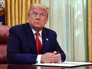 US President Donald Trump looks on before signing the pardon for Alice Johnson, in the Oval Office of the White House in Washington, DC, on August 28, 2020. Trump granted Johnson, a criminal justice reform advocate and former federal prisoner, a full pardon after commuting her sentence in 2018. NICHOLAS KAMM / AFP