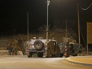 Israeli soldiers gather near the site of a fire on the border fence with Syria, near the Druze village of Majdal Shams in the Israel-annexed Golan Heights on August 31, 2020. JALAA MAREY / AFP