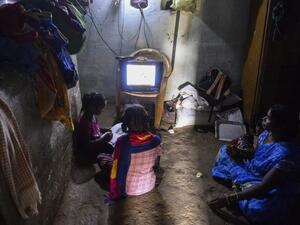 Government Primary School students follow the e-education classes telecasted on the T-SAT Network and Doordharshan TV network channels as their mum watches at their home in Nagireddypally village of Siddipet District, some 50 kms from Hyderabad on September 1, 2020. The Telangana State Education Board started on September 1 its alternative 2020-2021 academic year e-education system through the T-SAT Network and Doordharshan TV network due to the Covid-19