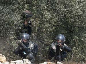 A member of the Israeli security forces fires a rubber bullet towards Palestinian protesters during clashes with Israeli security forces following a demonstration to protest Israel's plan to annex parts of the occupied West Bank, in the village of Kfar Qaddum, on September 4 2020. JAAFAR ASHTIYEH / AFP