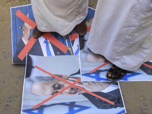 Palestinian men step on the portrait of the Israeli Premier during a protest in Deir al-Balah, in central Gaza Strip, on September 12, 2020, to condemn the normalisation of ties between Israeli and Bahrain. The Palestinian cause has long cemented ties between Middle East nations with divergent interests, but amid shifting regional alliances they are increasingly isolated and in need of new friends, analysts say. In the latest blow, Bahrain broke ranks and agreed on Friday to open diplomatic ties with Israel
