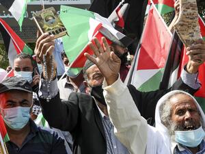 Demonstrators, mask-clad due to the COVID-19 coronavirus pandemic, demonstrate with Palestinian flags during a protest against the United Arab Emirates' and Bahrain's decisions to normalise relations with Israel, in the centre of the flashpoint city of Hebron in the occupied West Bank on September 15, 2020. Palestinian leaders had earlier called for demonstrations against the "shameful" deals the United Arab Emirates and Bahrain are set to sign with Israel. Officials from both Gulf states are due to attend 