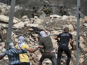 Palestinian protesters hurl stones at Israeli security forces during a demonstration in the village of Kfar Qaddum on September 25, 2020. (AFP/File Photo)