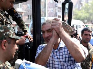 A man gestures boarding a bus to depart to the breakaway Nagorno-Karabakh region after Armenian authorities declared military mobilisation following armed clashes with Azerbaijan, Yerevan, September 28, 2020. Stepan Poghosyan / PHOTOLURE / AFP