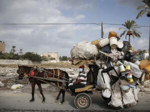 A Palestinian man collects plastic containers on his horse cart while wearing a protective mask due to the COVID-19 coronavirus in Deir al-Balah in the central of Gaza Strip on October 1, 2020. MOHAMMED ABED / AFP A Palestinian man collects plastic containers on his horse cart while wearing a protective mask due to the COVID-19 coronavirus in Deir al-Balah in the central of Gaza Strip on October 1, 2020. MOHAMMED ABED / AFP