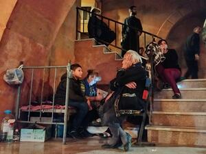 People shelter in the basement of the main church of the breakaway Nagorno-Karabakh region's main city of Stepanakert on October 4, 2020, during the ongoing fighting between Armenia and Azerbaijan over the disputed region. AFP