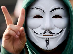 A protester wearing a mask flashes V-sign during a rally demanding to free jailed activists of the opposition in Minsk, on October 4, 2020. Belarusian police on October 4, 2020 used water cannon to disperse a rally in Minsk as tens of thousands of demonstrators took to the streets in the latest weekend protest against strongman Alexander Lukashenko's disputed re-election. STRINGER / AFP