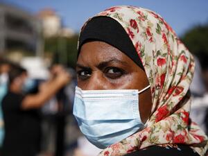 A Palestinian woman, wearing a protective face mask, takes part in a demonstration to how their support to prisoners held in Israeli jails, in Gaza City on October 5, 2020. Mohammed ABED / AFP