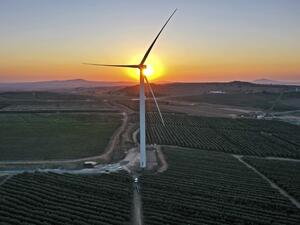 A picture taken on October 5, 2020, shows a wind turbine constructed between vineyards and fruit orchards as part of a wind farm, near El Rom settlement in the Israeli-annexed Golan Heights by the border with Syria. MENAHEM KAHANA / AFP
