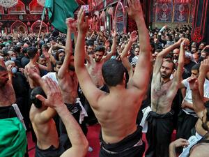 Shiite Muslim men take part in a mourning ritual in Iraq's central holy city of Karbala, on October 8, 2020, a day ahead of Arbaeen, which marks the end of the 40-day mourning period for the seventh century killing of Imam Hussein, Prophet Mohammed's grandson. Mohammed SAWAF / AFP