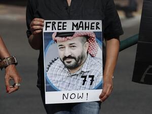 Israeli left-wing activists lift a placard bearing the picture of Palestinian administrative detainee Maher al-Akhras during a demonstration calling for his release after his health has deteriorated while on hunger strike for 77 days, in front of Kaplan medical center where he is in Israeli custody, in the central city of Rehovot, on October 11, 2020. Ahmad GHARABLI / AFP