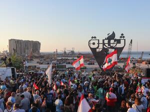 Lebanese protesters gather to light the "October 17 torch" marking the one year anniversary of the beginning of a nationwide anti-government protest movement, in front of the devastated port of the capital Beirut where a massive explosion took place more than two months ago, on October 17, 2020. ANWAR AMRO / AFP