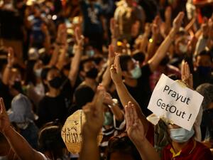 A sign directed at Thailand's Prime Minister Prayut Chan-O-Cha is held up by a pro-democracy protester during an anti-government rally on the ouskirts of Bangkok on October 19, 2020. Jack TAYLOR / AFP