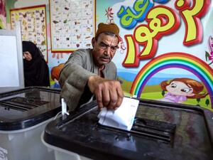 A man casts his ballot at a polling station in El-Ayyat, south of the Egyptian capital on October 24, 2020, during the first stage of the lower house elections. Polling stations opened in Egypt for parliamentary elections in which there was little doubt of a sweeping victory for supporters of hardline President Abdel Fattah al-Sisi. Some 63 million voters out of Egypt's more than 100 million people are eligible to elect 568 of the 596 lawmakers in the lower house, widely seen as a rubber-stamp body for exec