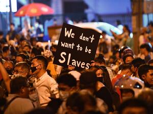 A pro-democracy protester holds a sign during an anti-government rally in Bangkok on October 26, 2020. Mladen ANTONOV / AFP