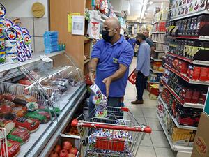 A worker removes french goods from the shelves of a supermarket in the Arab neighbourhood of Beit Hanina in Israeli-annexed east Jerusalem on October 26. (AFP)