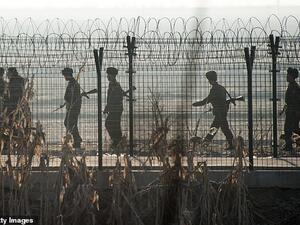 North Korean troops by a border fence with China. (AFP)