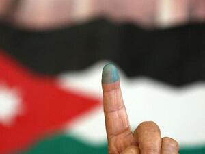 A Jordanian woman shows her ink-stained finger after voting Tuesday morning in the parliamentary elections. (AFP/Khalil Mazraawi) A Jordanian woman shows her ink-stained finger after voting Tuesday morning in the parliamentary elections. (AFP/Khalil Mazraawi)
