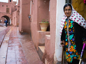 lady in traditional clothes in the ancient village of Abyaneh, near Kashan, in Iran. In background, the typical red mud-brick houses of Abyaneh  (Shutterstock)	
