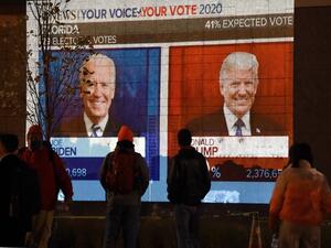 People watch a big screen displaying the live election results in Florida at Black Lives Matter plaza across from the White House on election day in Washington, DC on November 3, 2020. Olivier DOULIERY / AFP