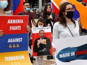 Members of the Armenian community in Israel hold banners in the coastal city of Tel Aviv on November 6, 2020, as they protest against Israel's arms sales to Azerbaijan and Turkey's support to the latter. JACK GUEZ / AFP