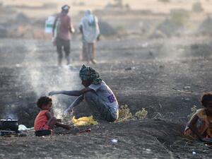 Ethiopian refugees who fled intense fighting in their homeland of Tigray, cook their meal in the border reception centre of Hamdiyet, in the eastern Sudanese state of Kasala, on November 14, 2020. Ethiopia's Prime Minister Abiy Ahmed, winner of last year's Nobel Peace Prize, ordered military operations in Tigray last week, shocking the international community which fears the start of a long and bloody civil war. Ebrahim HAMID / AFP