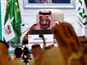 Media persons gathered at the International Media Centre in Saudi Arabia's capital Riyadh on November 21, 2020 watch on a projected screen as Saudi King Salman bin Abdulaziz gives an address opening the G20 summit, held virtually due to the COVID-19 coronavirus pandemic. AFP