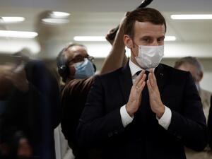 French President Emmanuel Macron speaks to volunteers during the 2020 Phoneton, an annual fundraising operation organised by the Hayastan All-Armenian Fund's French affiliate (Fonds Armenien de France) for the development of Armenia and Artsakh, on November 21, 2020 in Paris. Ludovic MARIN / POOL / AFP