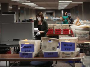 Claire Woodall-Vogg, executive director of the Milwaukee election commission collects the count from absentee ballots from a voting machine on November 04, 2020 in Milwaukee, Wisconsin. Wisconsin requires election officials to wait to begin counting absentee ballots until after polls open on election day. The Milwaukee count was finished about 3AM. Scott Olson/Getty Images/AFP